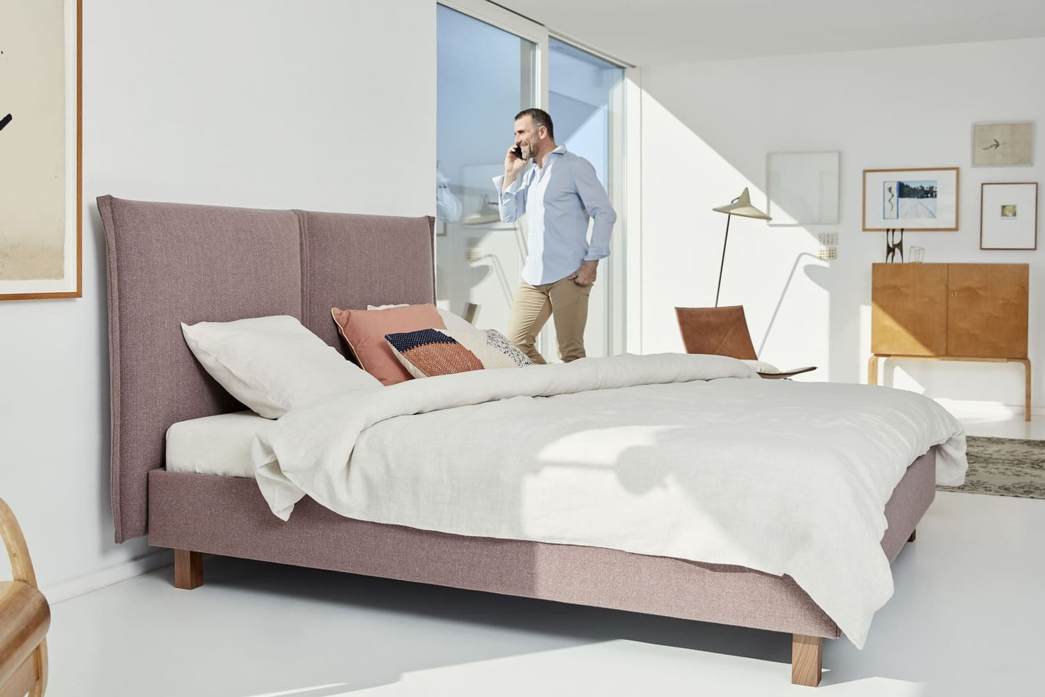Lit Lattoflex 1 dans une chambre moderne, avec un homme au téléphone près de la fenêtre