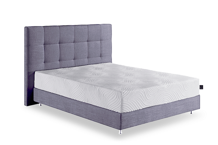 Matelas Bliss Talalay sur un lit avec tête de lit capitonnée grise, design moderne et élégant